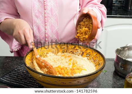 Couscous being prepared by a Moroccan immigrant woman in her modern European kitchen