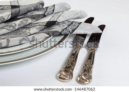 Vintage tableware and folded napkins in silver and grey