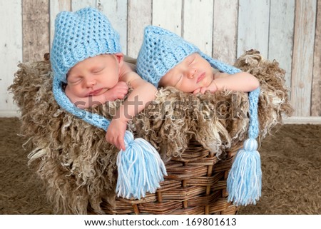 Ten days old newborn twin babies asleep together