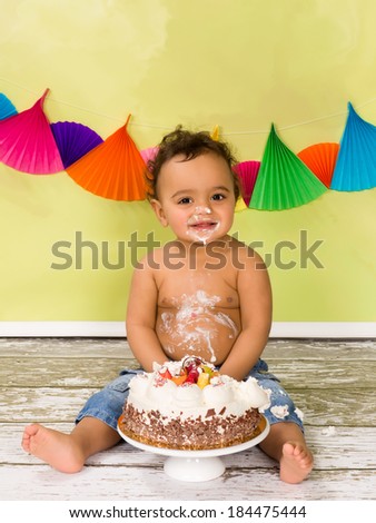 Adorable african baby during a cake smash on his first birthday