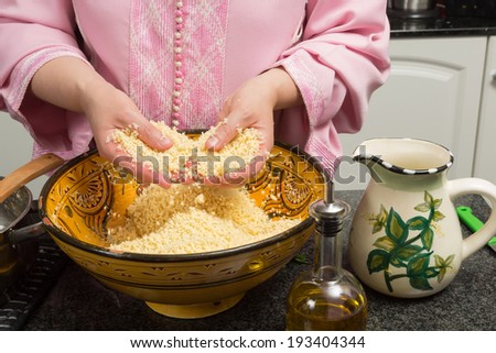Couscous being prepared by a Moroccan immigrant woman in her modern European kitchen