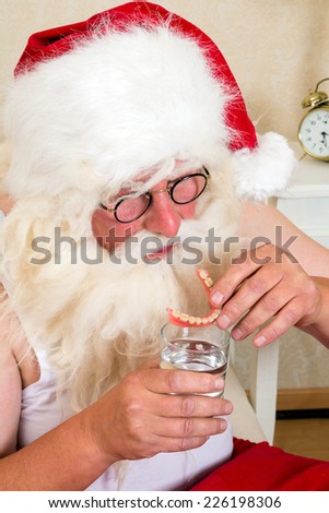 Morning ritual of Santa Claus, putting his false teeth in