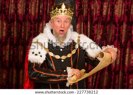 Senior king making an announcement holding a parchment scroll