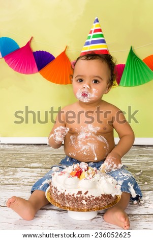 Adorable african baby during a cake smash on his first birthday