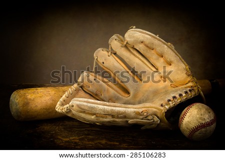 Dark still life with baseball glove, bat and ball
