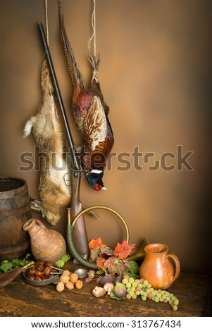 Autumn still life with hunting products, pheasant and hare