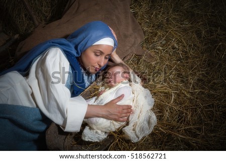 Live Christmas nativity scene in an old barn - Reenactment play with authentic costumes.  The baby is a (property released) doll.