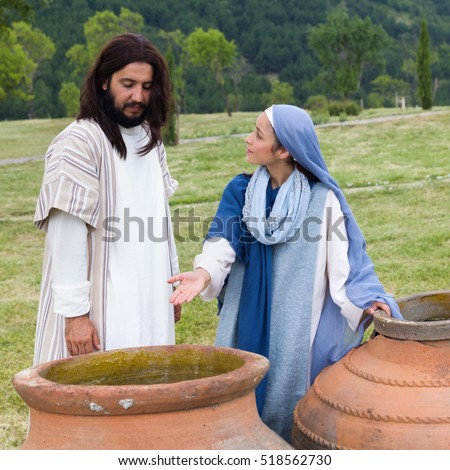 Biblical scene play of the miracle of transformation of water into wine - Mother Mary saying to Jesus there is no wine left