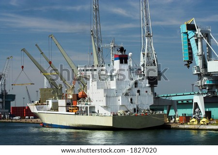 Cargo ship being unloaded at Antwerp harbor (all brand names and logos have been removed)