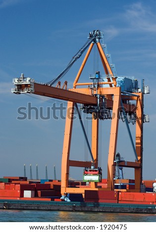 Containers being loaded into cargo vessels at Antwerp harbor (all brand names and logos have been systematically removed)