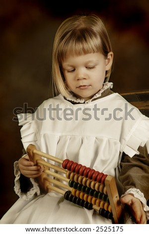 Victorian style photo of a little girl counting with an abacus