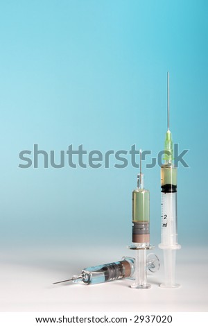 A large and two small syringes for flu vaccination