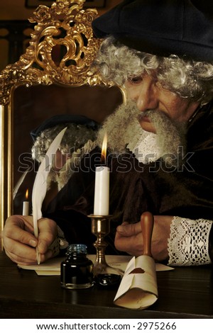 Historically dressed man writing his will (or a letter) with a goose feather - lighting is Rembrand style,