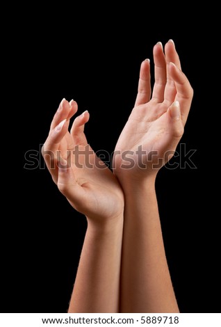 Elegant and well manicured hands against a black background