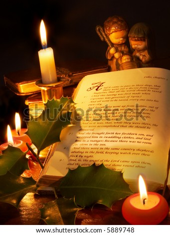 The story of christmas highlighted in an old bible, with candles