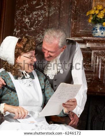 Vintage scene of a Victorian couple reading good news in a letter. Shot in the antique castle \