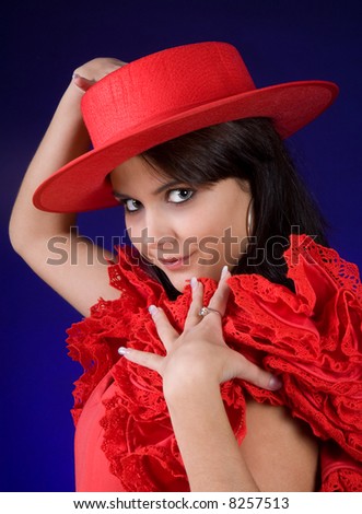 Young Spanish Flamenco dancer showing her red hat