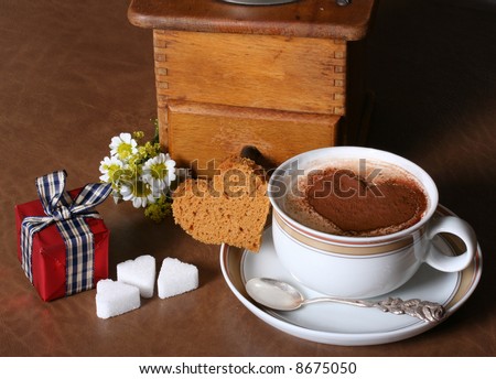 Cup of hot coffee, decorated with flowers, a little gift, heart-shaped sugar, for his/her loved one