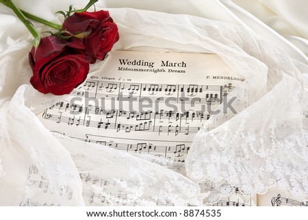 stock photo Sheet music of the Wedding March with roses and bridal veil