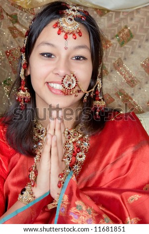 Young Indian beauty giving the Namaste greeting from India