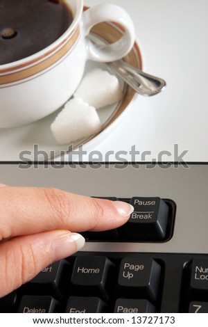Finger pressing the break/pause button, it\'s coffee break