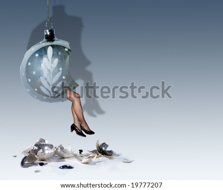 Sexy female legs coming out of a broken christmas decoration