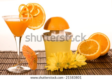 Oranges, parasol and a yellow orange squeezer
