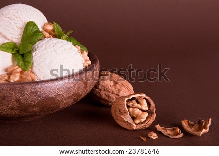 Vanilla ice cream bowl with fresh walnuts