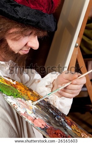Vintage artist making a painting with pallet and brushes