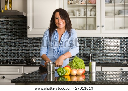 Young woman opening a can of food in the kitchen