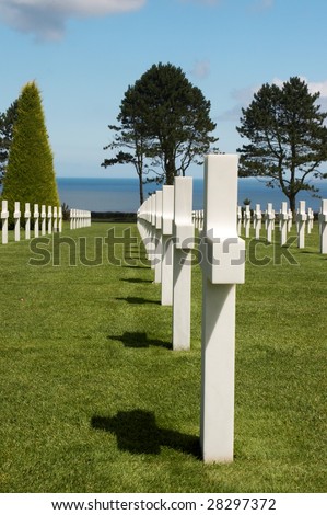 Rows of graves overlooking the Atlantic Ocean at the American war cemetery in Normandy, France
