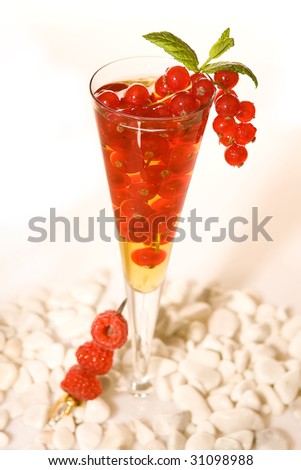 Red cocktail decorated with red berries and raspberries