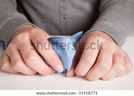 Hands of a crying woman holding a handkerchief