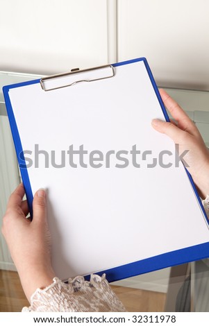 Female hands holding an empty clipboard with copy-space