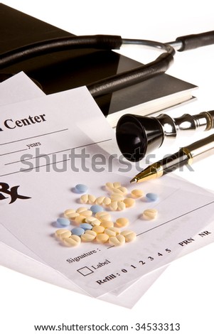 Handful of little pills lying on a doctor\'s prescription