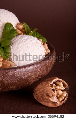 Vanilla ice cream bowl with fresh walnuts