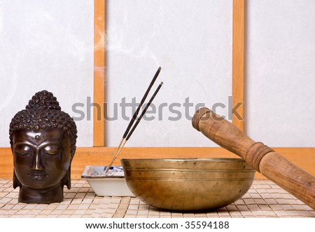 Oriental chime and incense with bronze buddha head