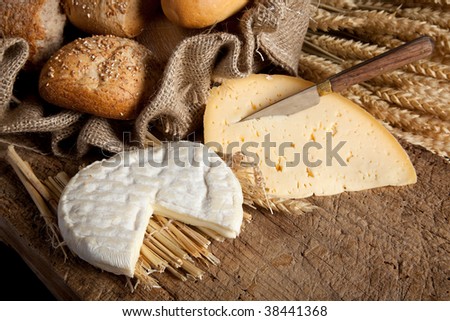 Vintage jute bag with bread rolls and French cheese