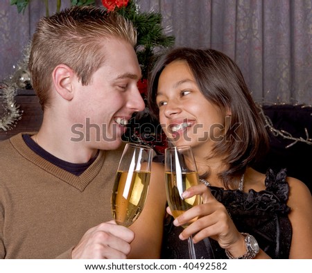 Young happy couple drinking champagne with christmas or new-year