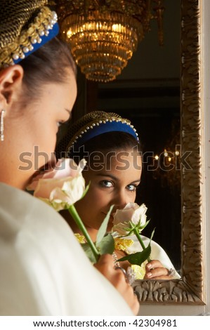 Beautiful young victorian lady in front of a mirror in Castle \
