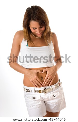 stock photo : Attractive young woman showing her navel piercing with the 