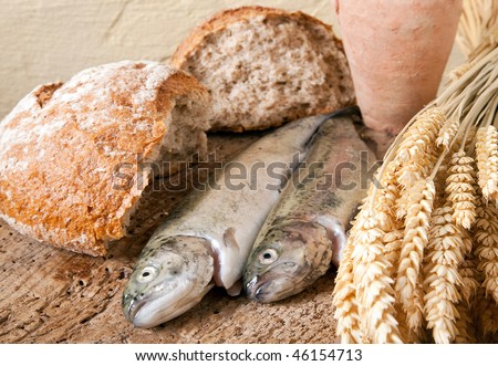Wine jug, bread and fish as symbols of christian religion