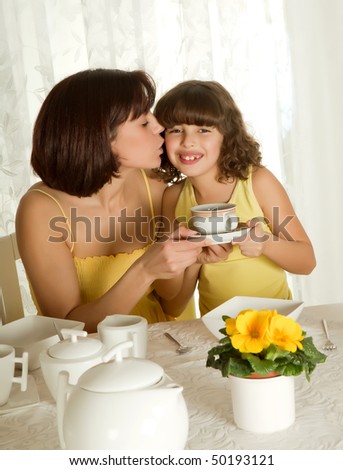 Little girl serving coffee for mother\'s day breakfast