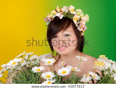 Springtime woman with butterfly and flower hair behind daisies