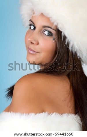 Winter girl with white fur hat wearing warm fur hat