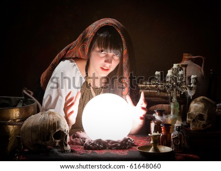 Young fortune-teller reading the future in a crystal ball