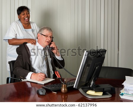 Cleaning woman giving the manager of the office a neck massage