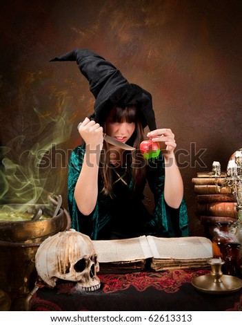 Halloween witch preparing a poisonous green apple (the book is 300 years old, no copyright problems)