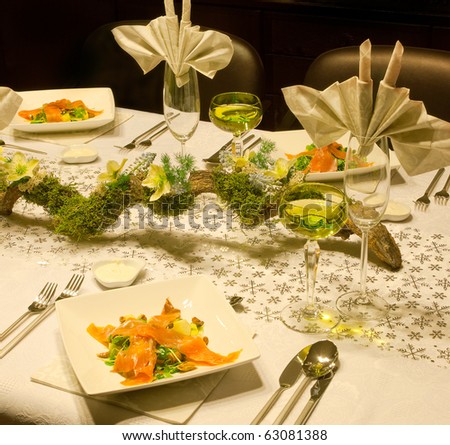 Smoked salmon dish on a festive table with flower arrangement