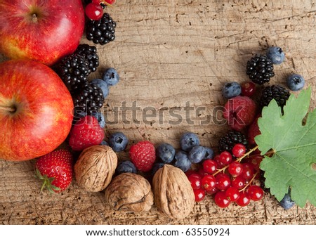 Thanksgiving border made of autumn fruits on a wooden board